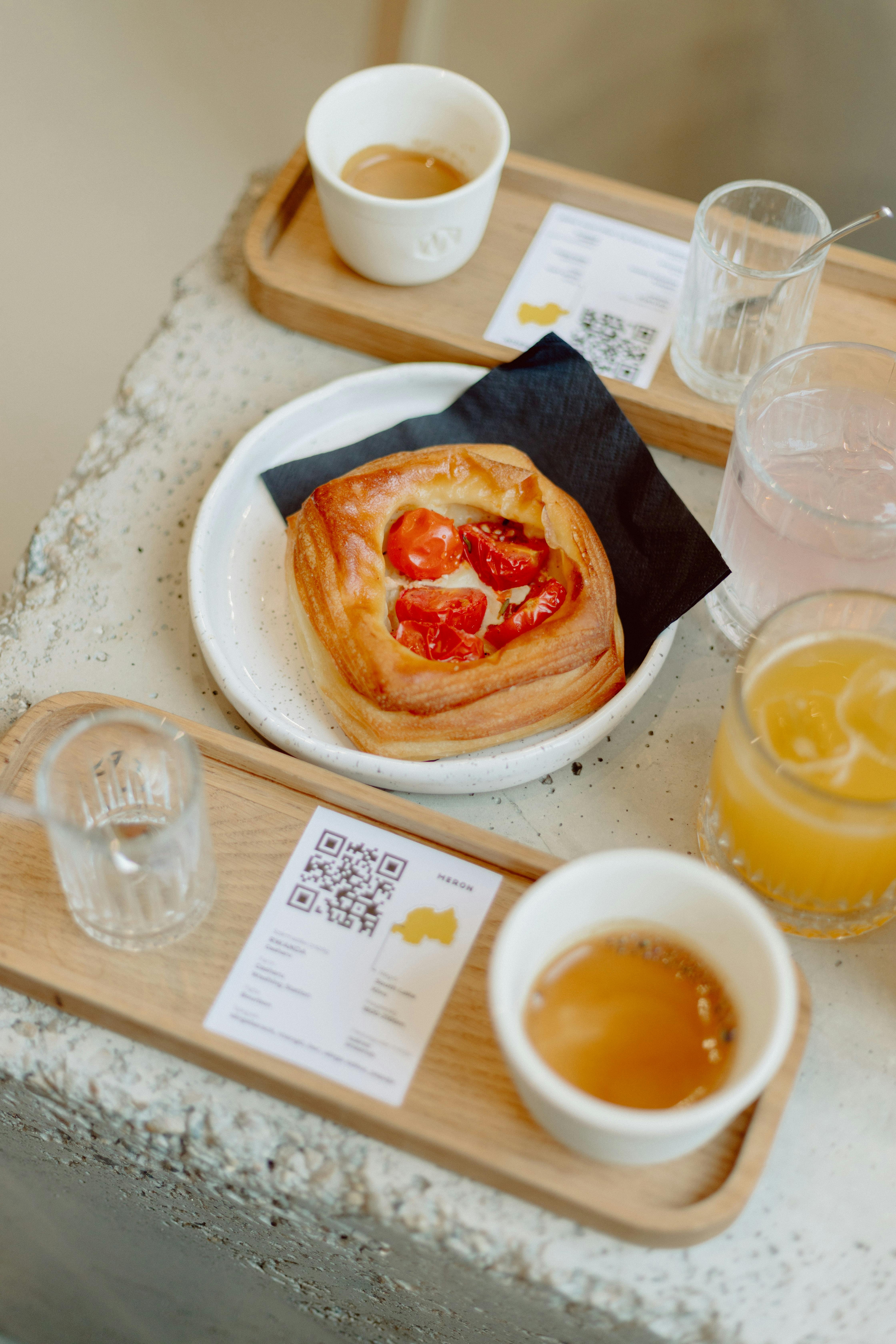 A gourmet pastry with fresh juice and coffee at a stylish Budapest café, beautifully arranged.