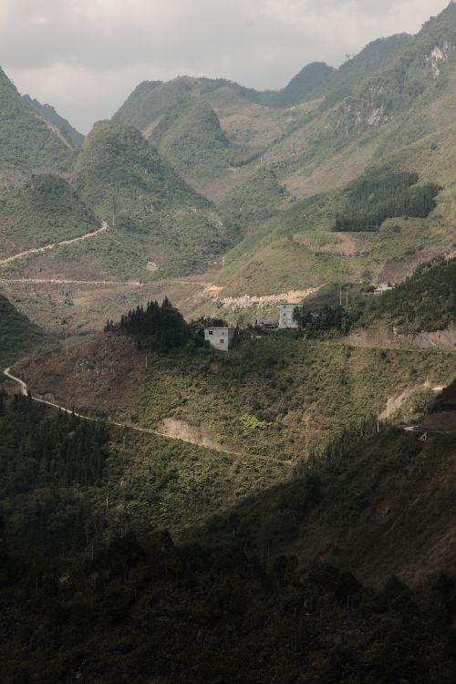 Free Breathtaking view of lush green mountains and winding road in summer. Stock Photo