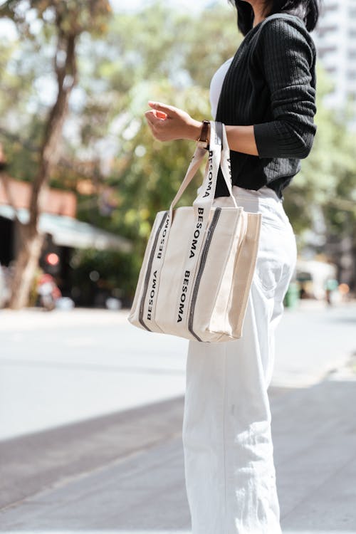 Woman in White Pants with Bag