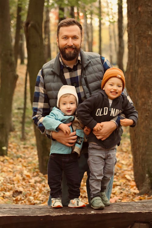 Father with Sons in Autumn Forest