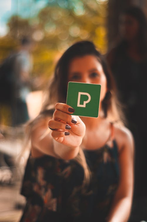 Person Holding Green P Card