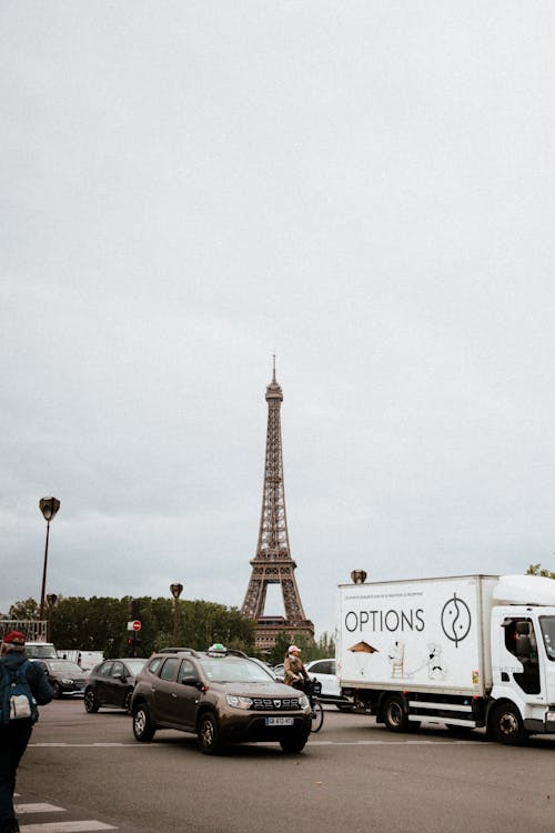 Eiffel Tower Behind Cars on Street in Paris, France