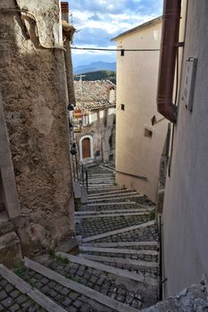 Charming cobblestone steps in a narrow alley of Castel del Monte, Italy.