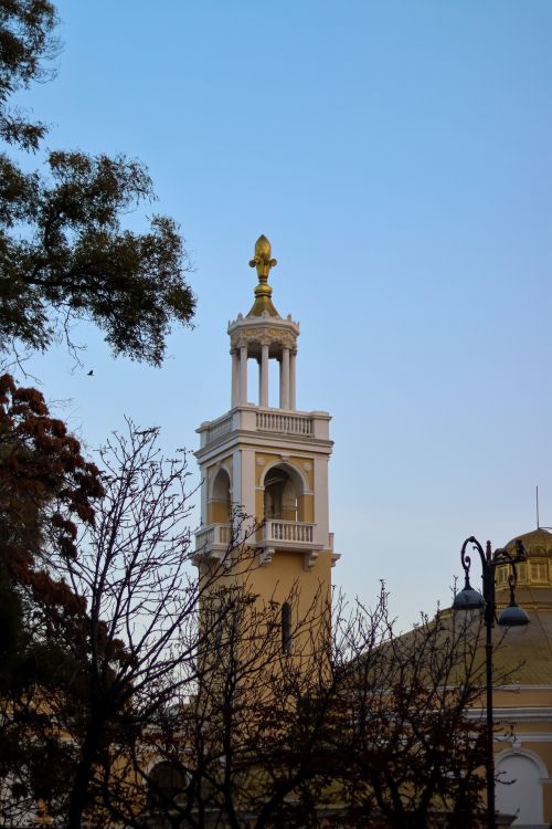 Free A beautiful tower in Baku, captured against a clear blue sky with surrounding trees. Stock Photo