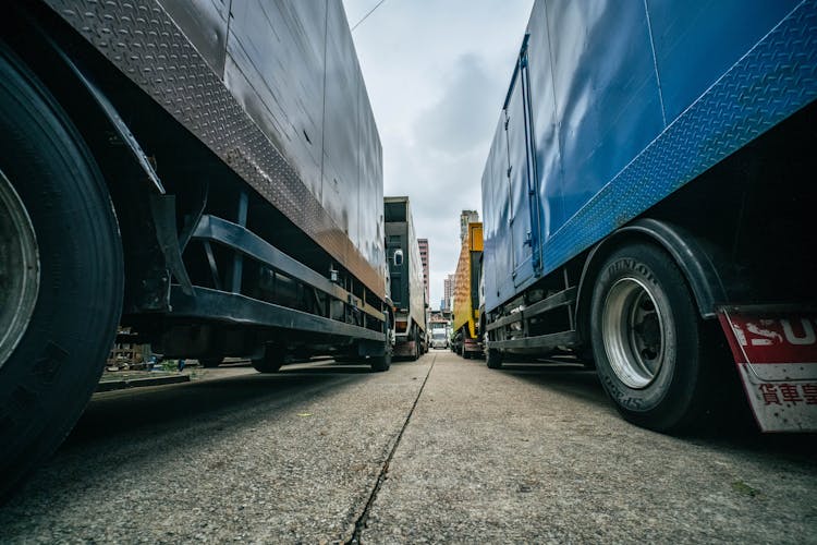 Low Angle Shot Of Trucks In Traffic 