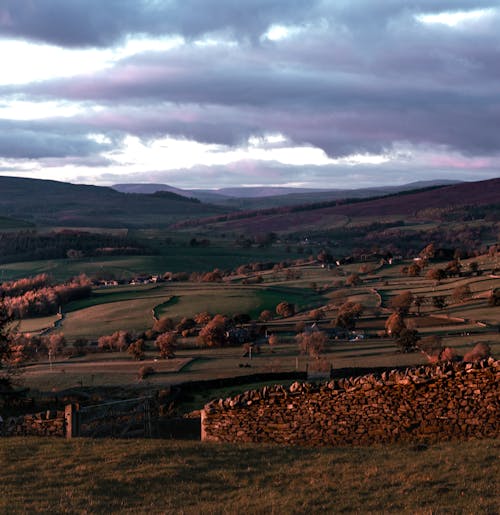 Rural Rolling Valley Landscape with Distant Mountains