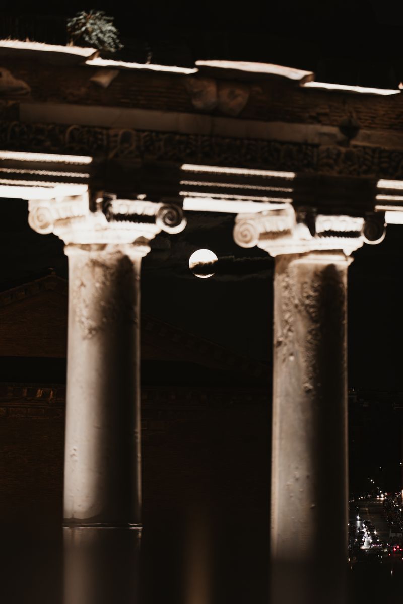 Moon and classical columns illuminated at night