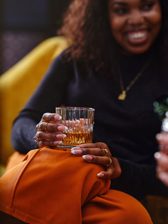 Woman Hands Holding Glass with Drink