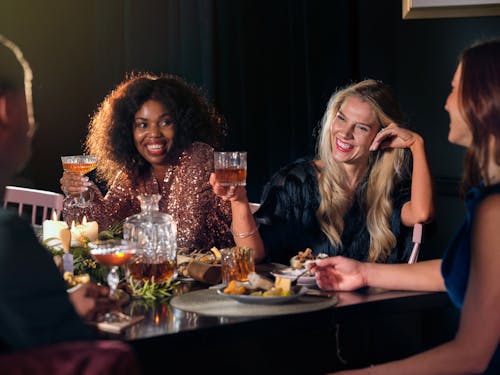 Friends Drinking Whiskey in a Restaurant