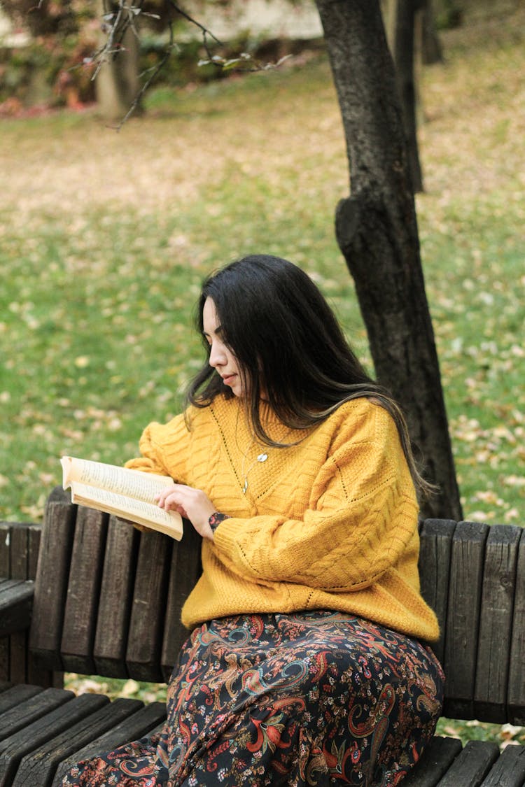 Woman Reading Book In Park