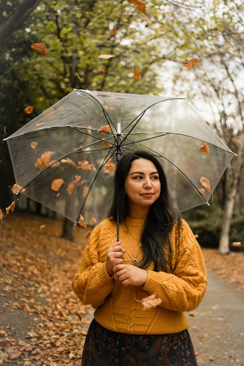 Woman Holding an Umbrella in a Park 