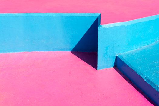Abstract photo of brightly colored blue and pink geometric steps creating a vibrant visual contrast.