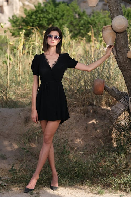Model in a Black Short Sleeved V-Neck Dress in the Countryside
