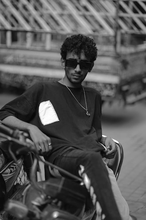 Young Man in Sunglasses Sitting on a Motorcycle 