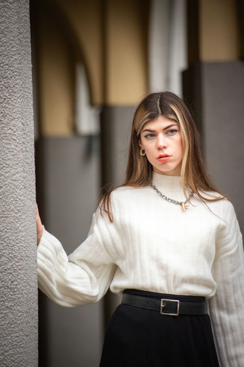 Woman in white turtleneck, minimalist professional outfit