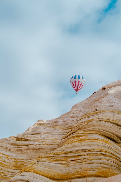 Hot Air Balloon Floating over Rock Formation