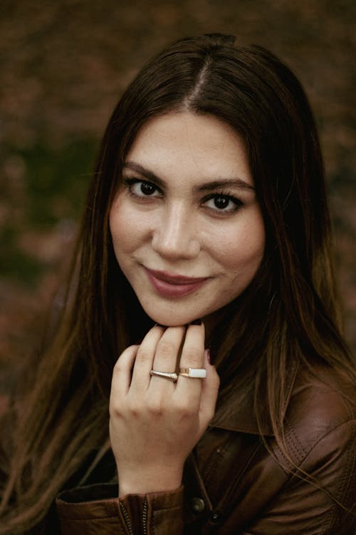 Portrait of a Woman with Long Brown Hair, Wearing Rings