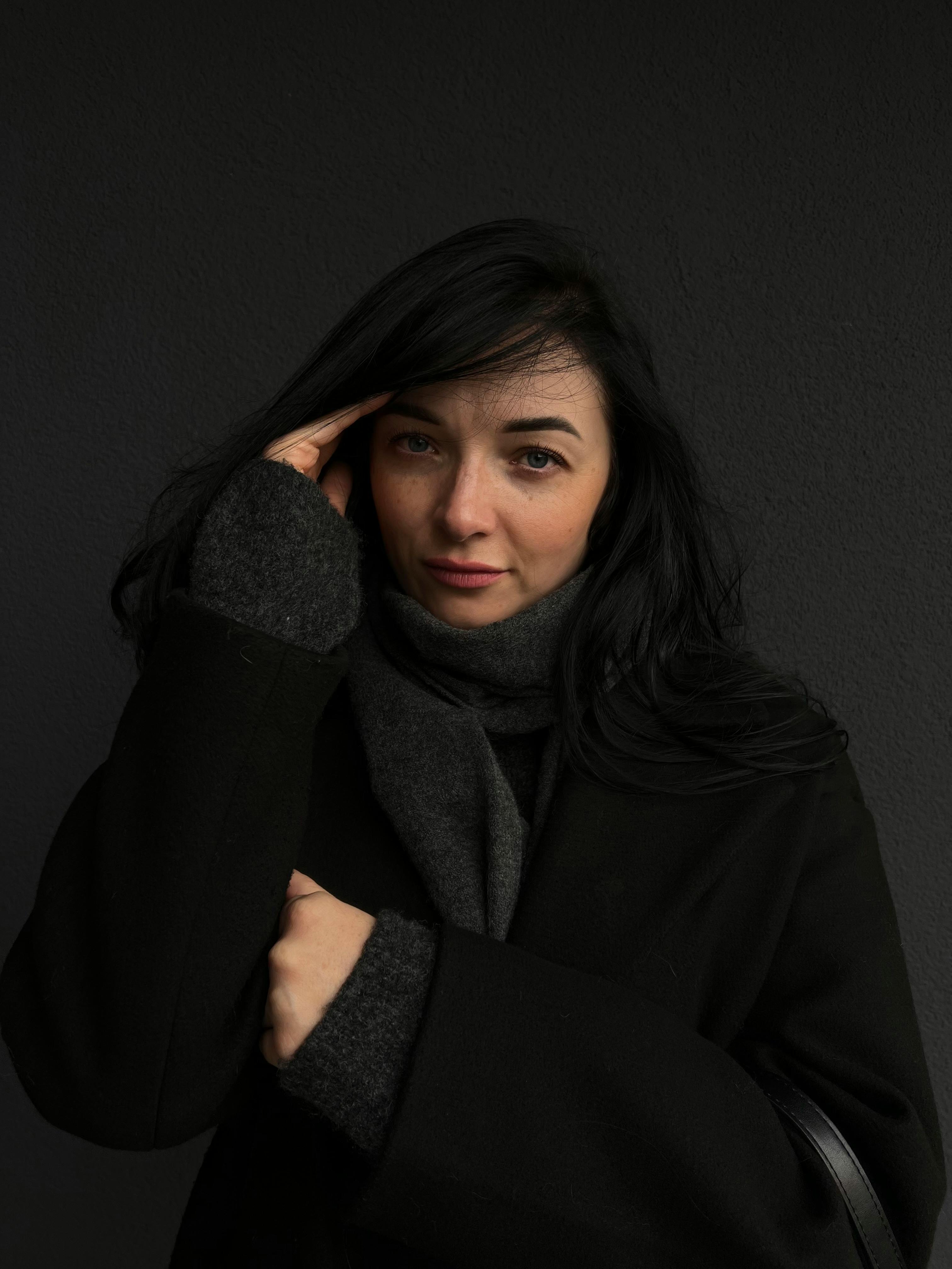 Portrait of a stylish woman in dark fashion, showcasing winter wear in the Netherlands.