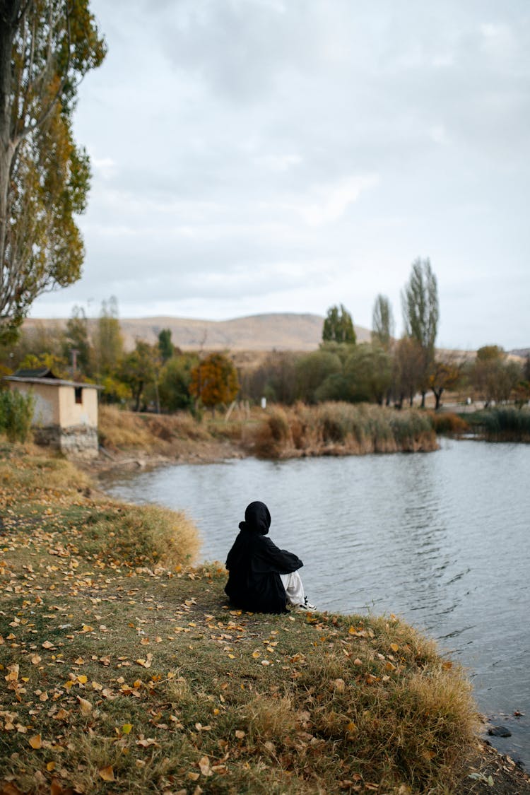 Landscape With A Person Sitting By A Pond