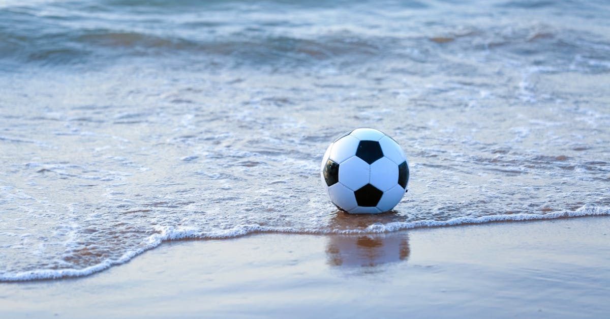 Soccer Ball on Sea Shore Free Stock Photo