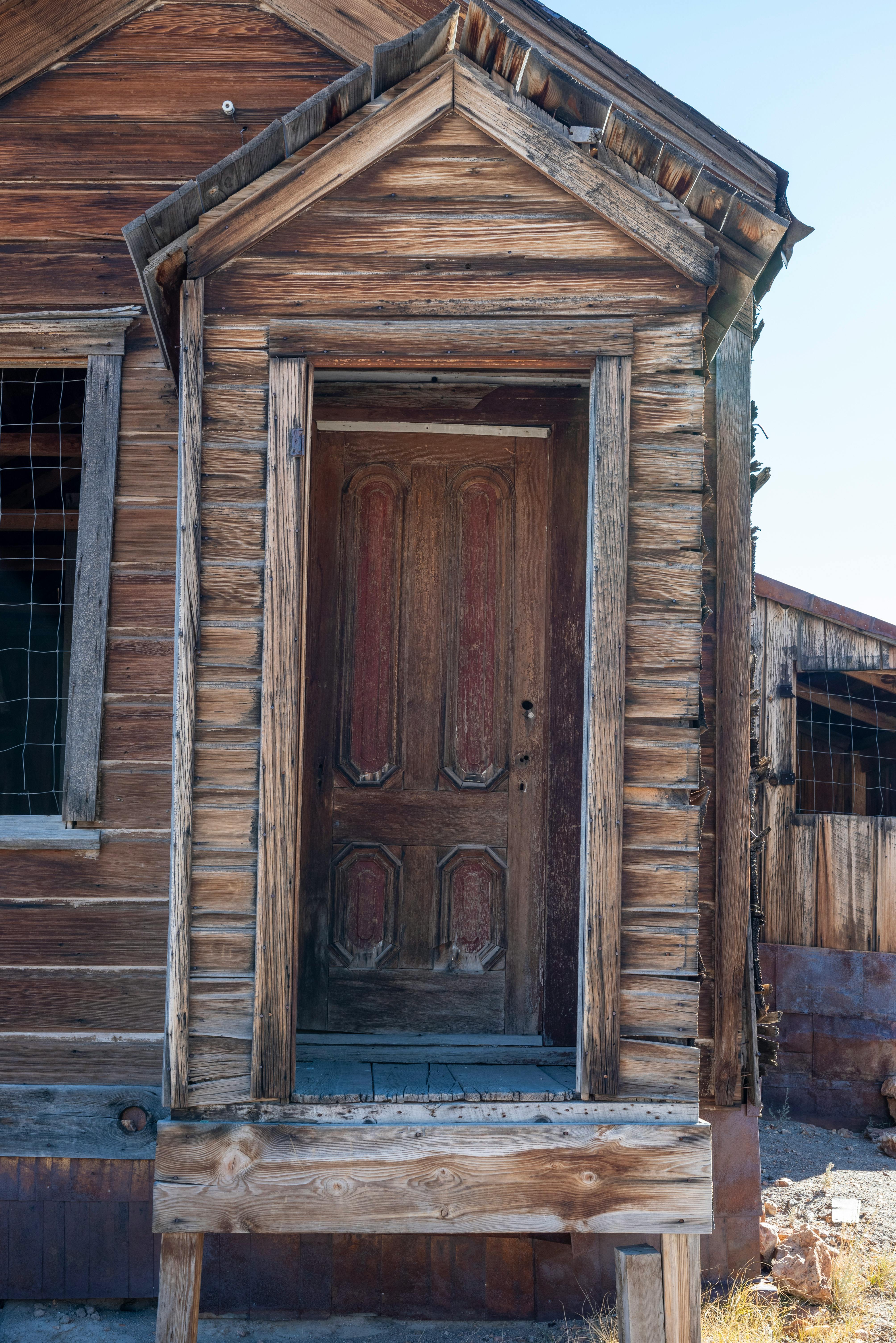 Close-up of a rustic wooden door in a traditional rural cottage.