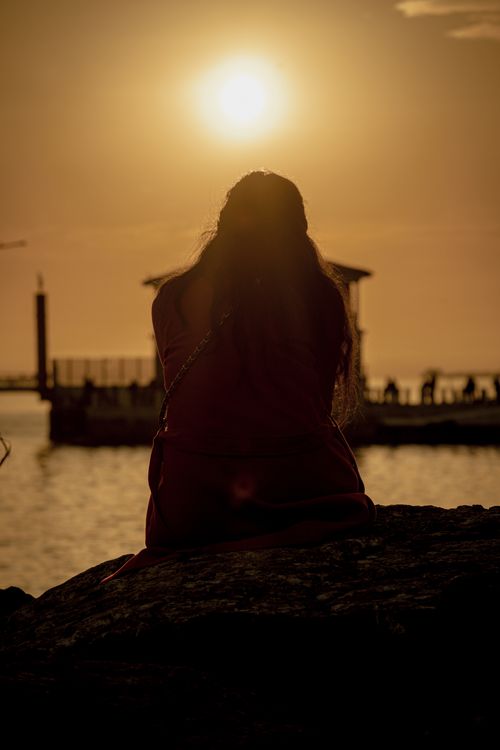 Silhouette of a Woman on a Beach at Sunset · Free Stock Photo