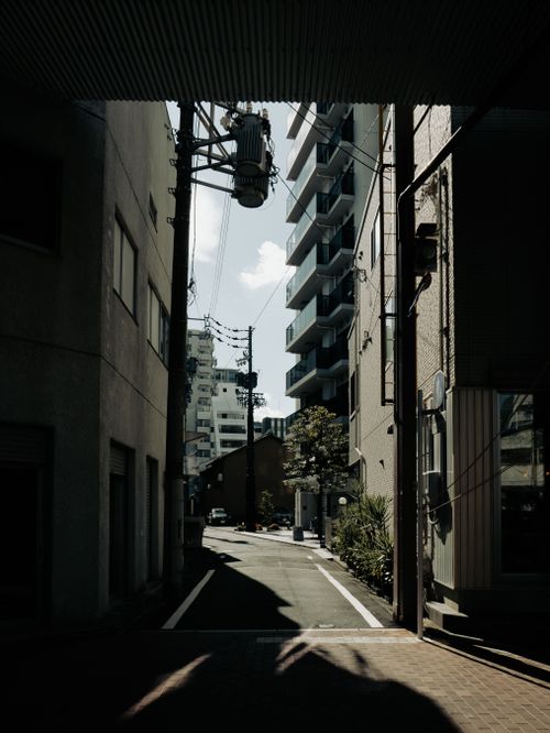 Free A narrow city street in Nagoya, Japan showcasing urban life and architecture. Stock Photo