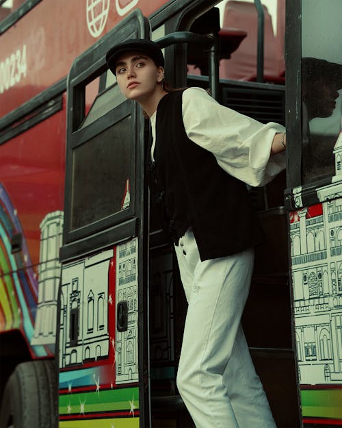 Woman in Vest Standing in Bus Door