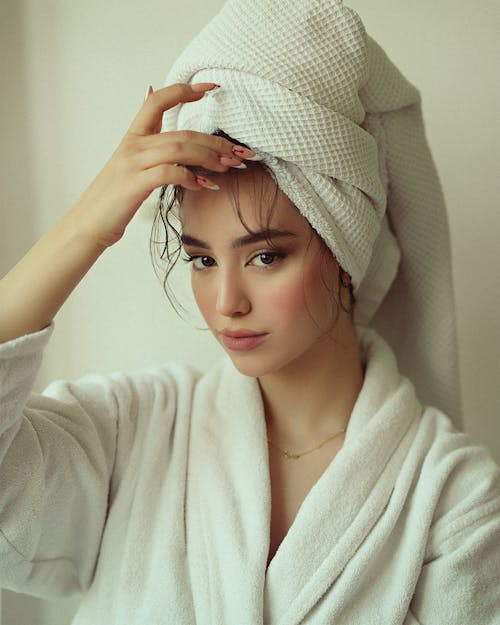 Young Woman Wearing a Towel on Her Head and a Bathrobe 