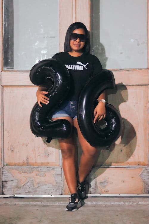 Girl Holding Black Balloons 