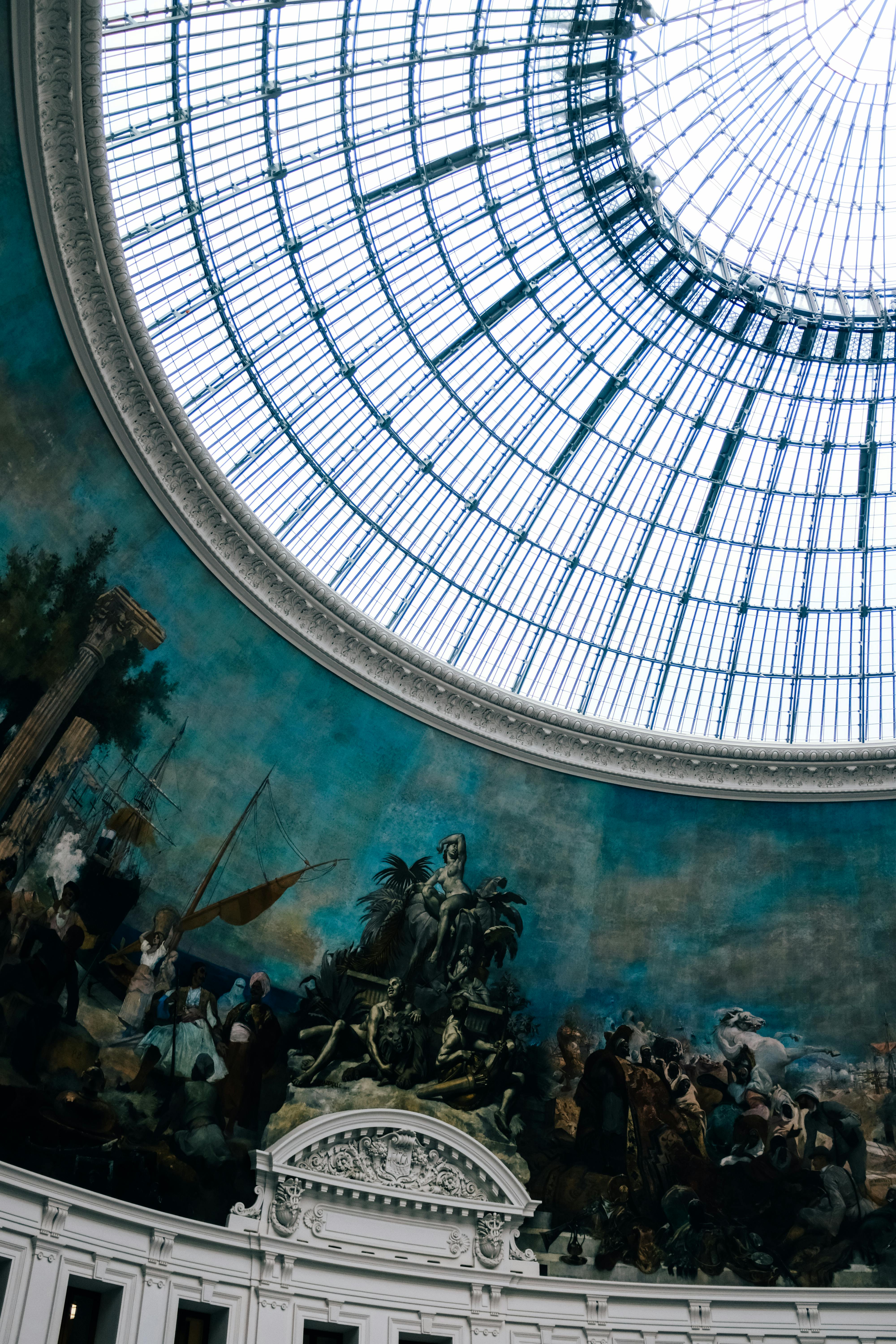 painting under glass ceiling in louvre