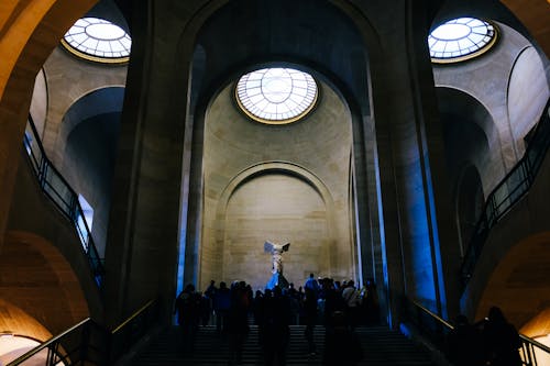 People on Stairs under Nike of Samothrace in Louvre