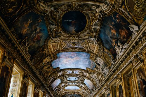 Free Stunning ornate Baroque ceiling in the Louvre, Paris showcasing exquisite artistic detail. Stock Photo