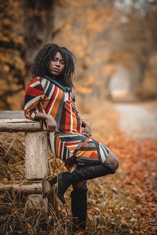 Woman in Abstract Pattern Dress Posing in Autumn Park · Free Stock Photo