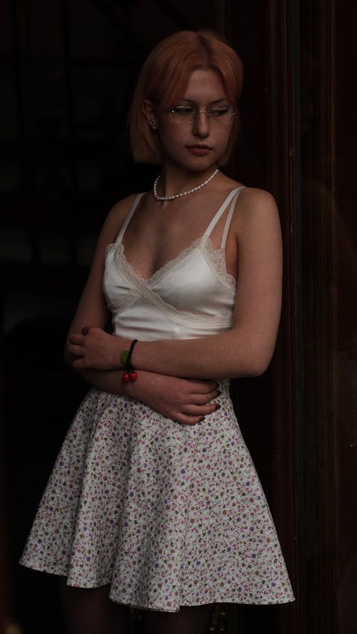 Young Woman in a White Top and a Floral Skirt