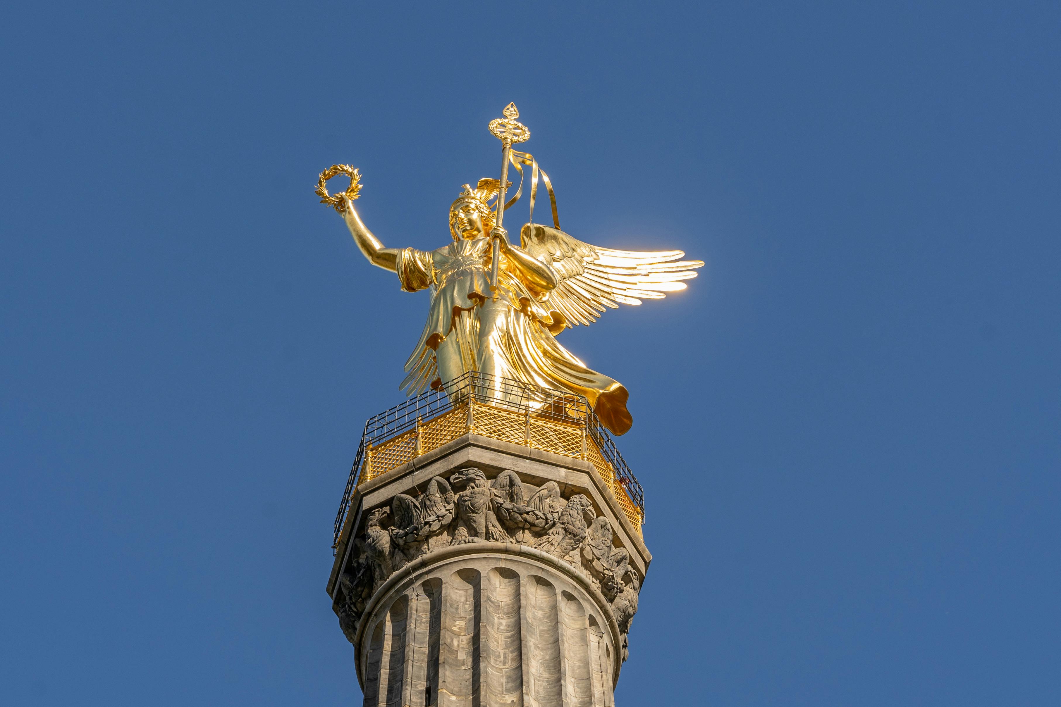 close up of the berlin victory column under clear blue sky