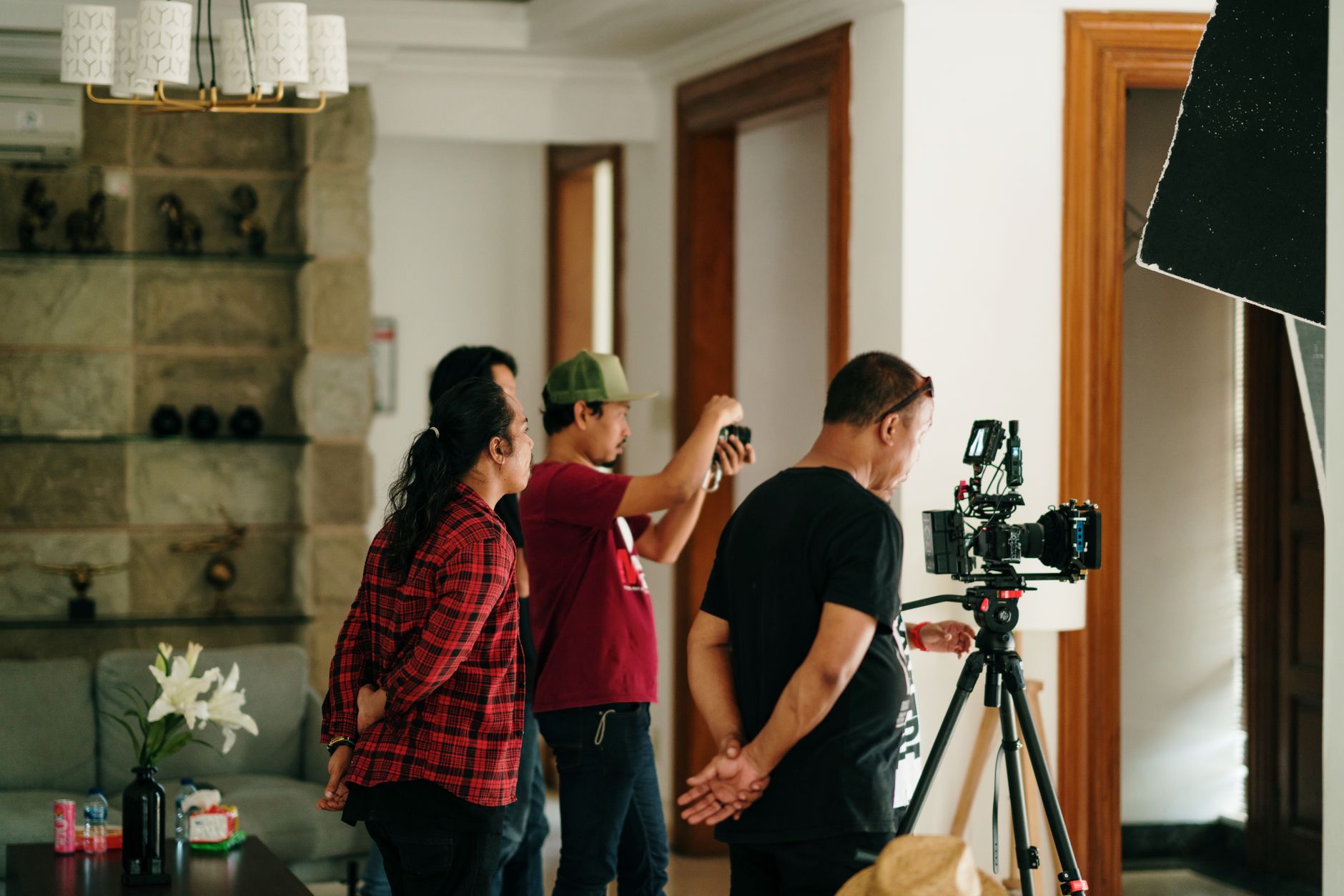 A professional photography crew working inside a studio with camera equipment.