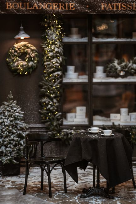 Warm inviting café setting, adorned with Christmas wreaths and snow, perfect for winter season.