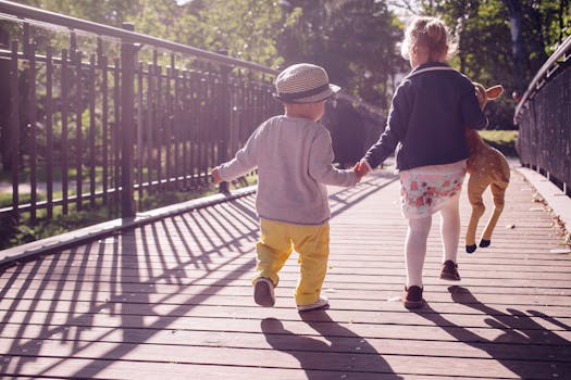 Boy and Girl Walking on Bridge during Daytime