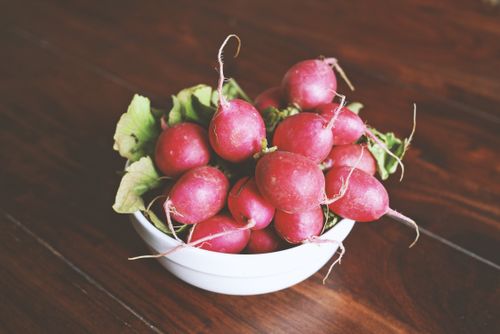 Free A close-up of vibrant red radishes in a bowl, showcasing their fresh and healthy appeal. Stock Photo