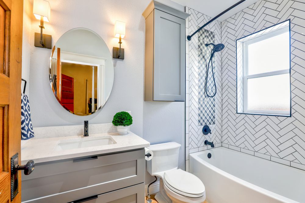 Renovated bathroom with vanity, bath and tiled walls waterproofed by HydroForce
