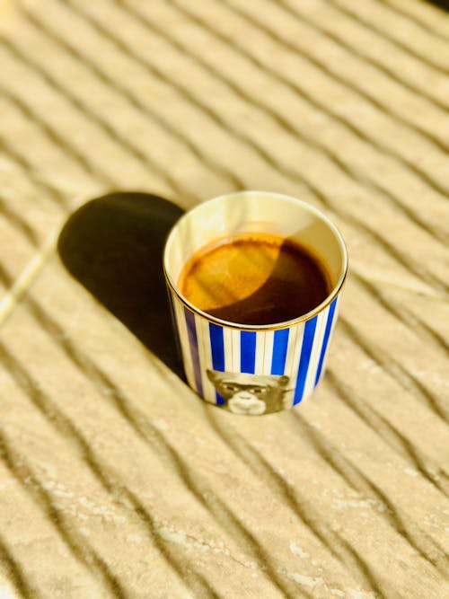 Free A Cup of Coffee Standing in Sunlight  Stock Photo