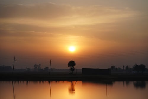 Hazy Sunset over Rural Landscape