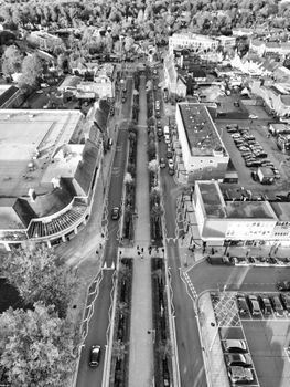 Aerial black and white view of an urban street in Hertfordshire, England, showcasing city life and architecture.