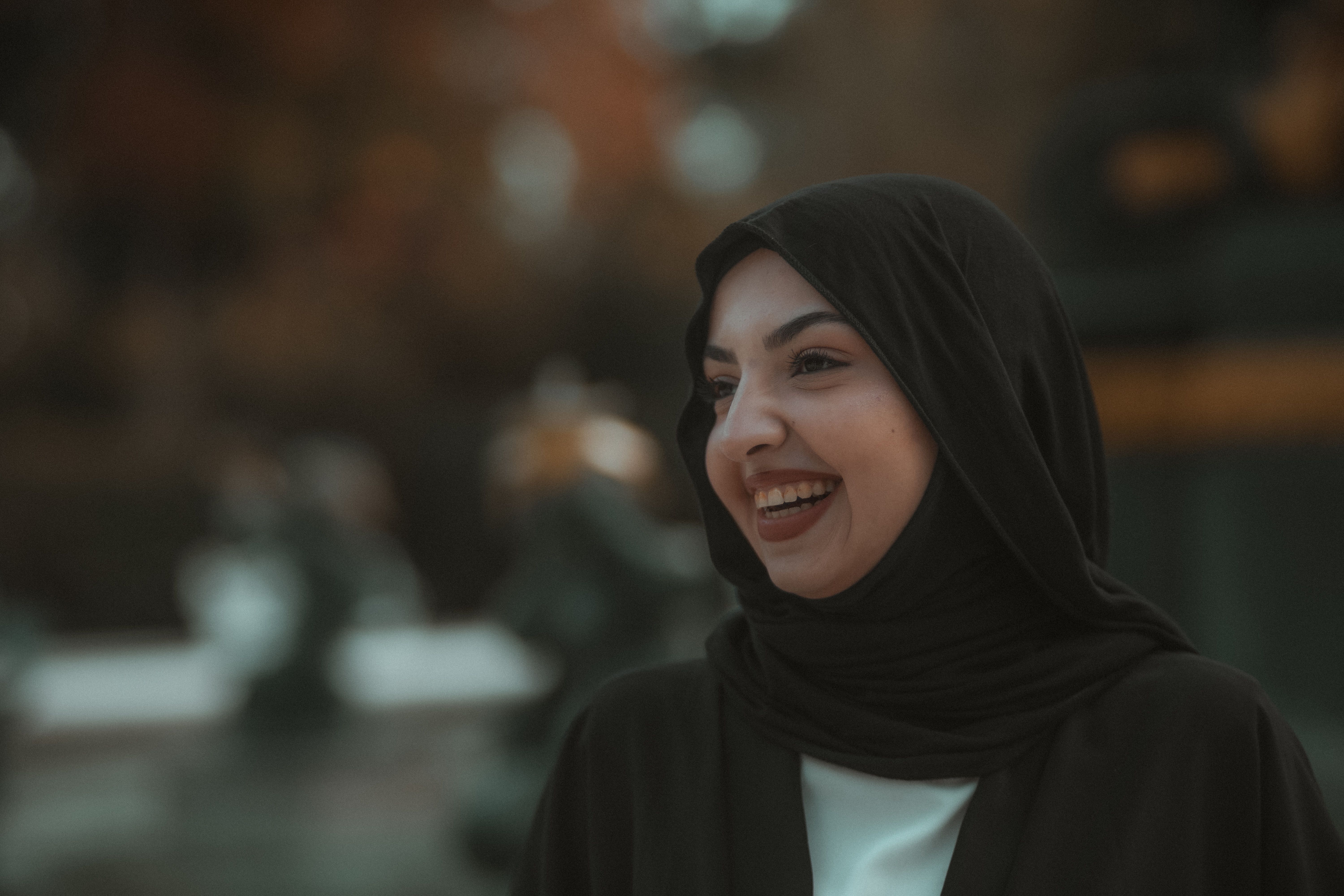 Young Woman in a Hijab Standing Outside and Smiling · Free Stock Photo