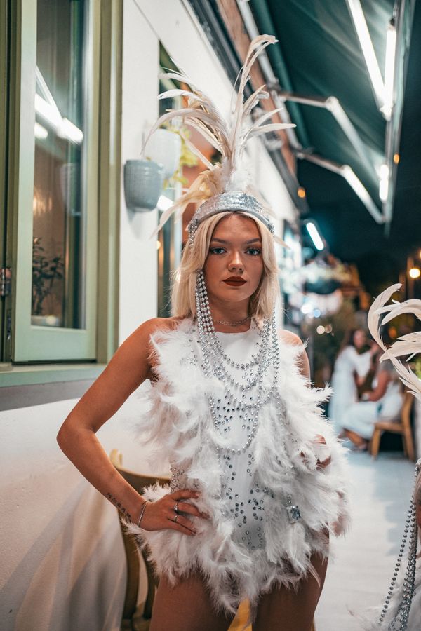 woman wearing feather trim top and mini skirt party night