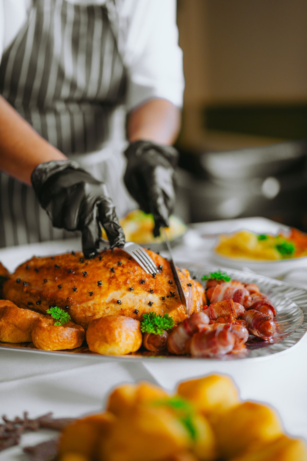 Chef carving a roasted meat at a catering event