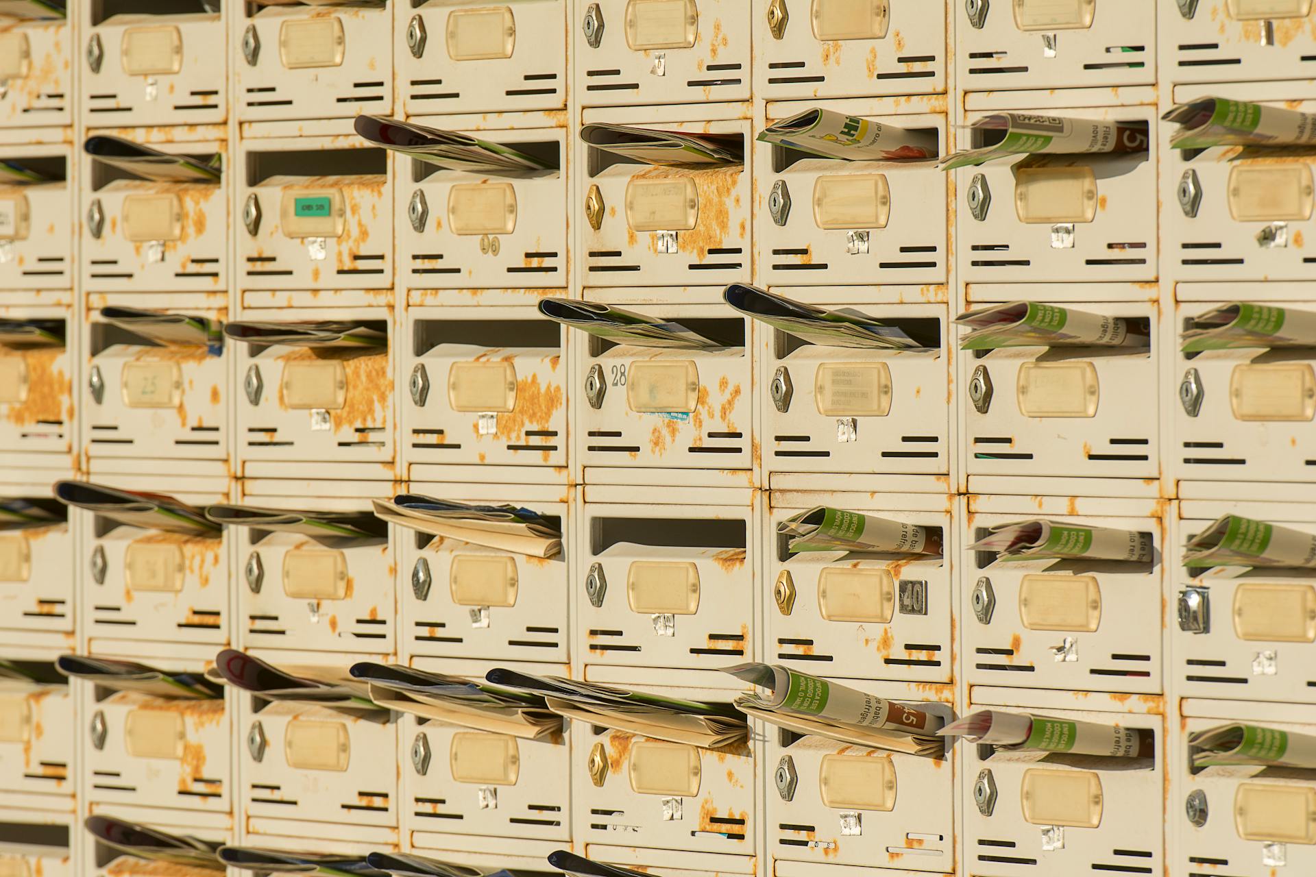 A Wall of Mailboxes with Newsletters Inside