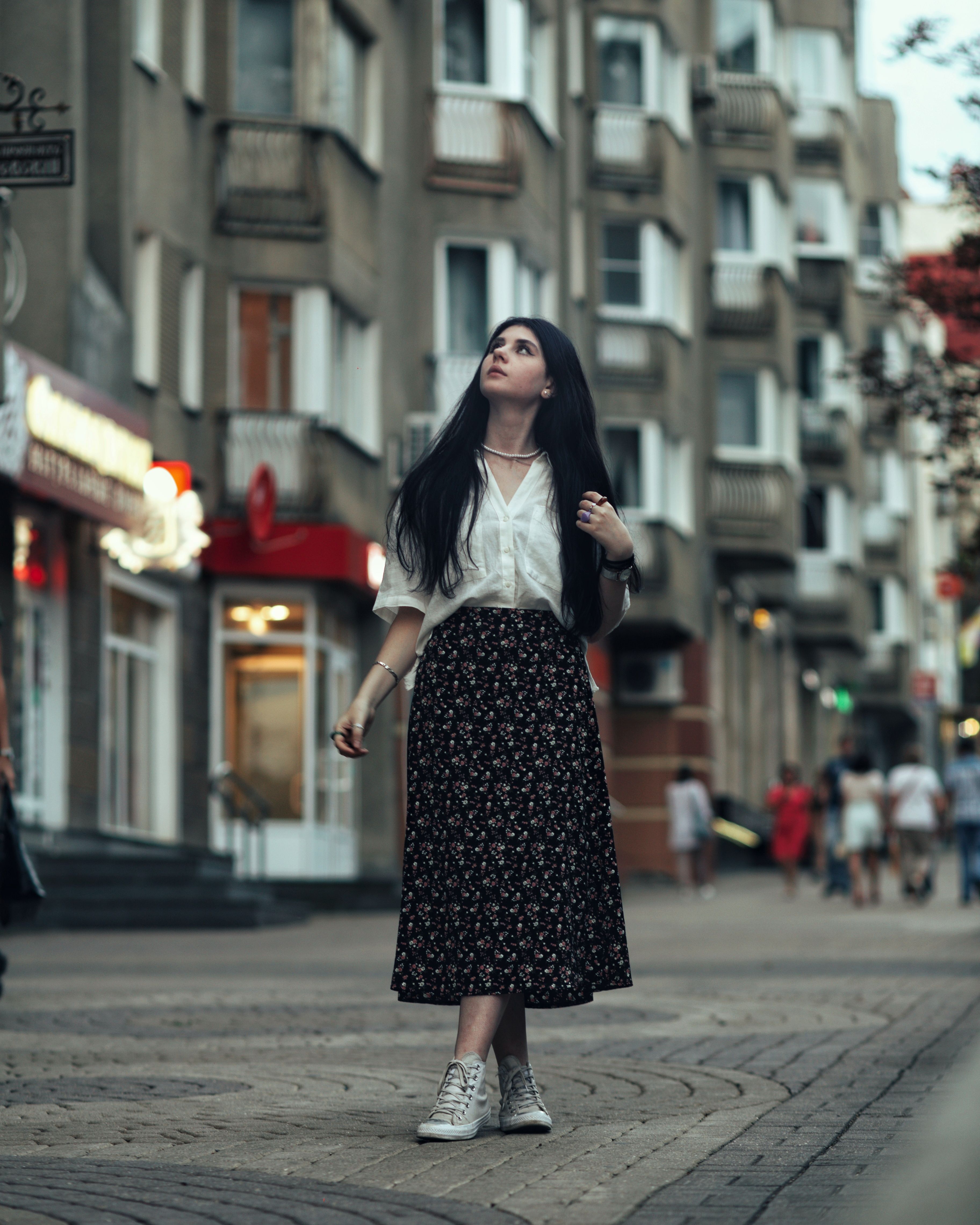 Young Woman in a Skirt Standing on the Sidewalk · Free Stock Photo