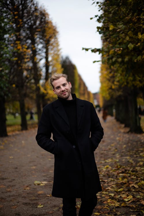 Smiling Man in Black Coat in Park